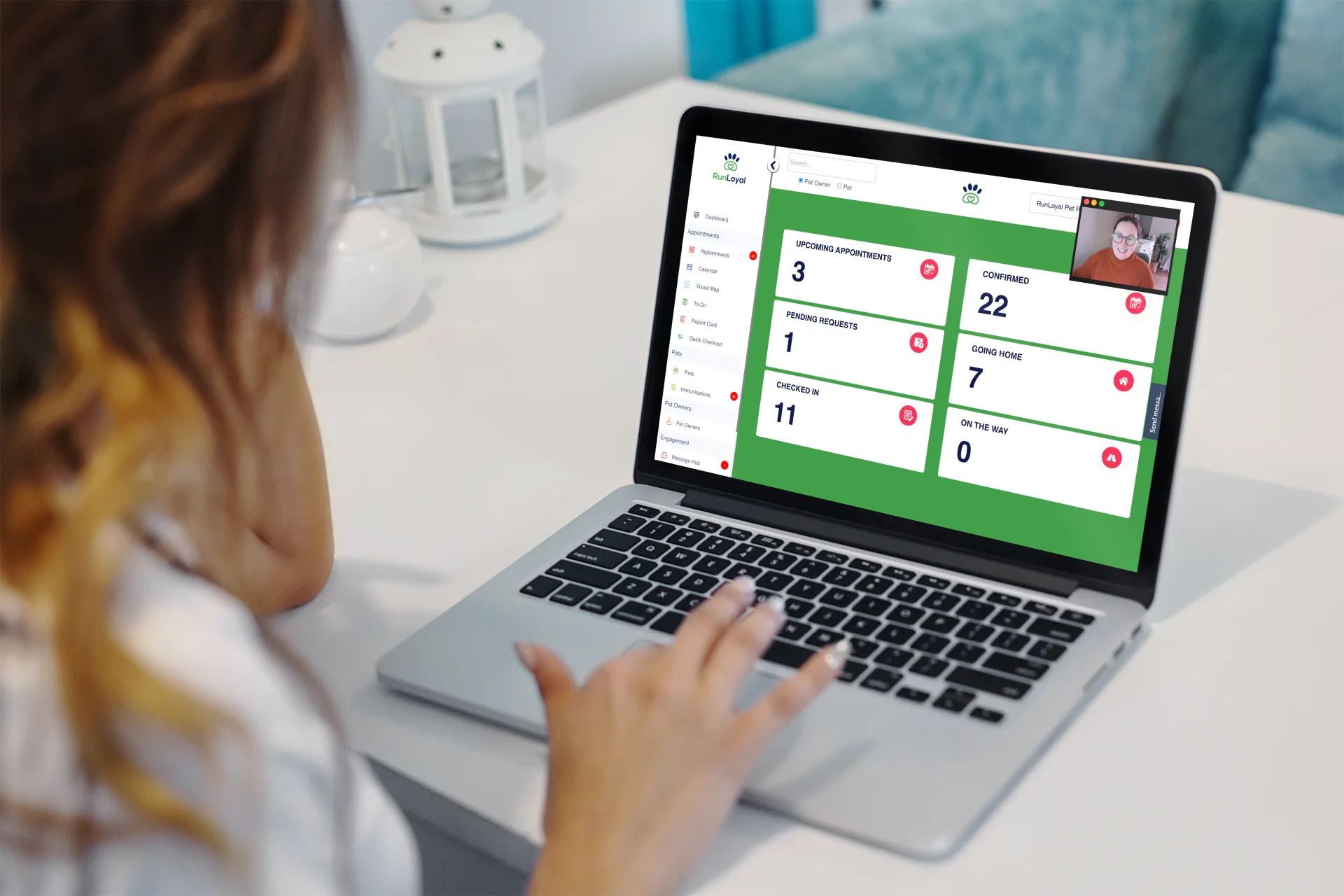 A pet care owner on a video onboarding call with a RunLoyal specialist while viewing the RunLoyal dashboard of upcoming, confirmed, and checked-in appointments